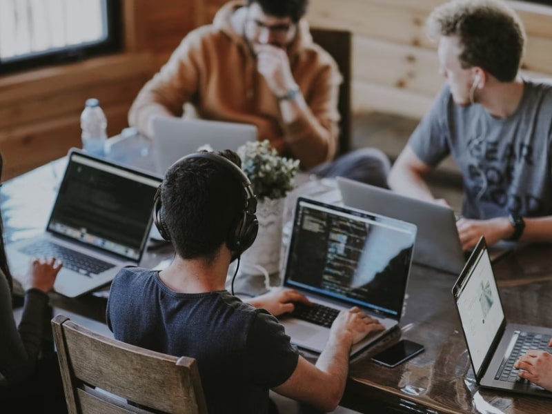 group of people working laptops