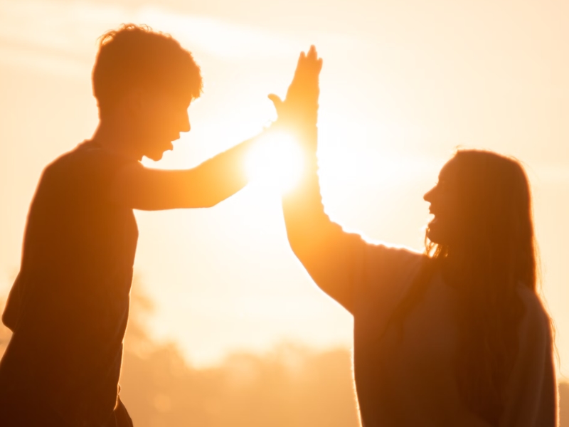 man and woman high fiving