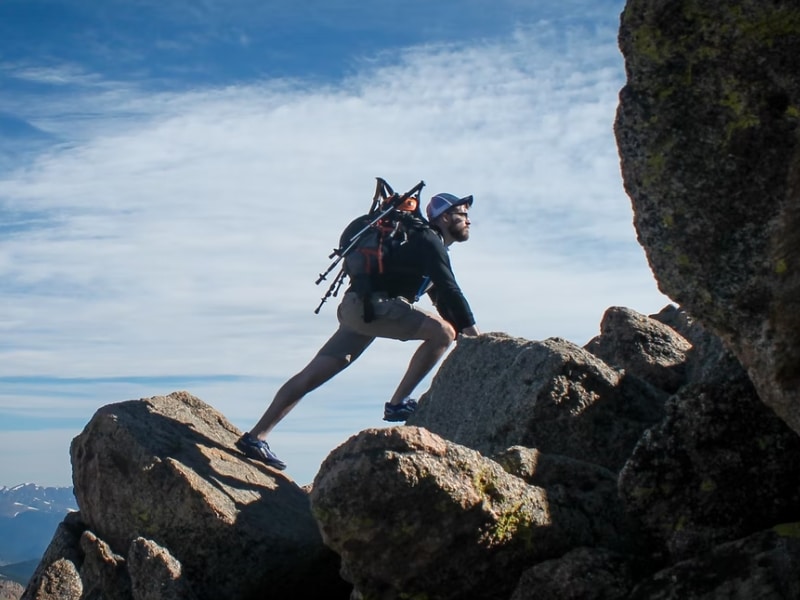 man climbing rocks