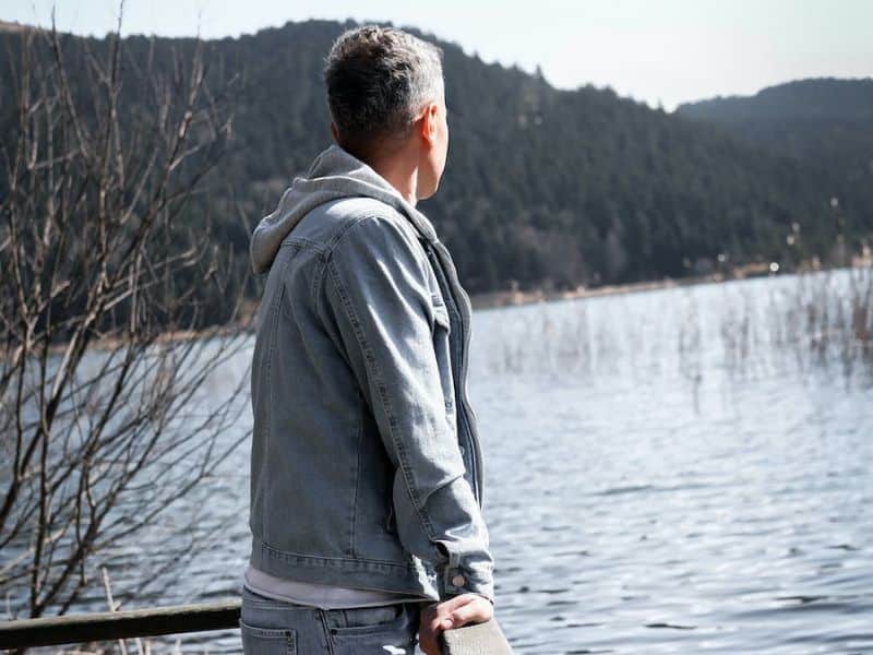 Man on Pier Looking at Lake