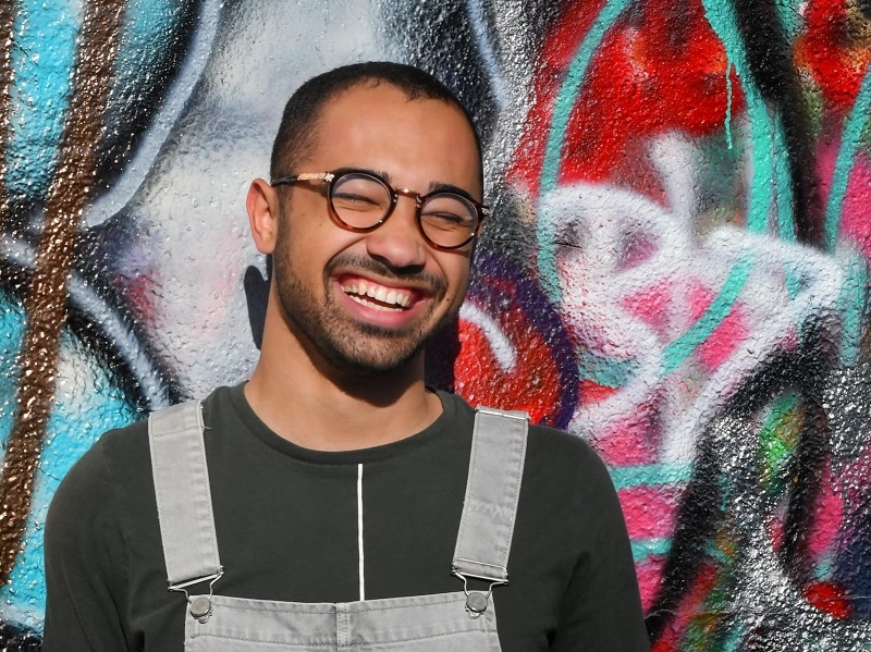 man smiling colorful background