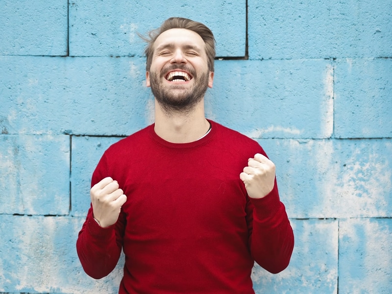 man smiling with fist pumped