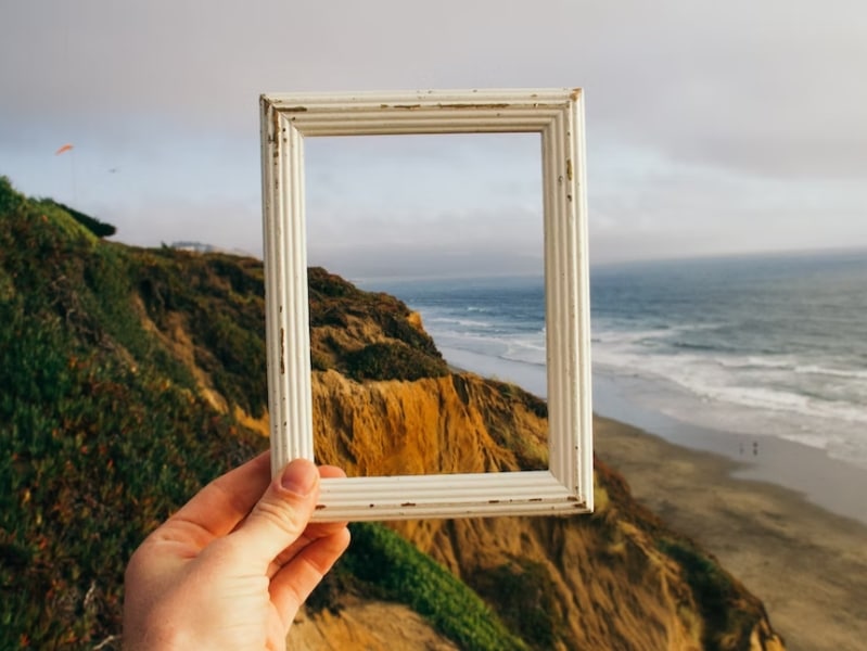 person holding frame in hand