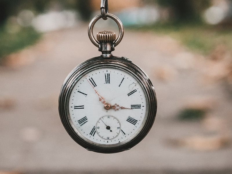 stopwatch clock hanging on chain