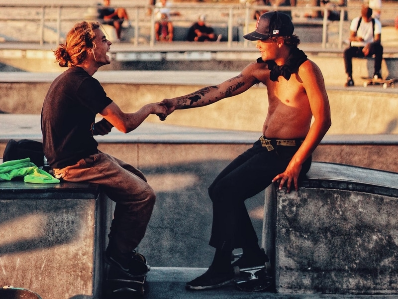 two men fist bump laughing