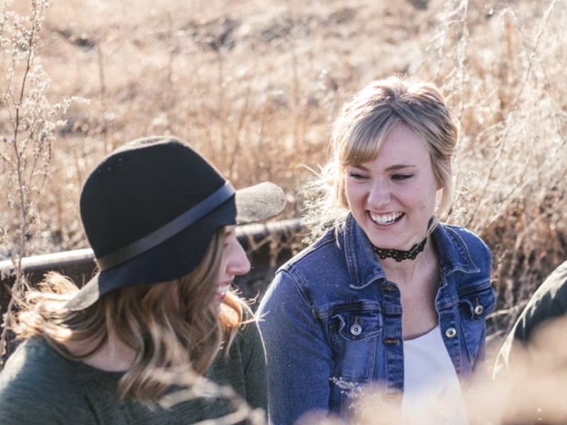 two women laughing to each other