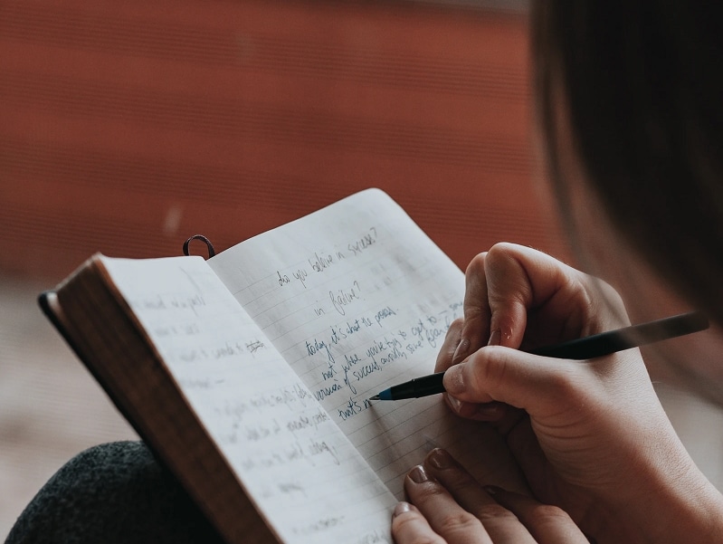 woman journaling in diary