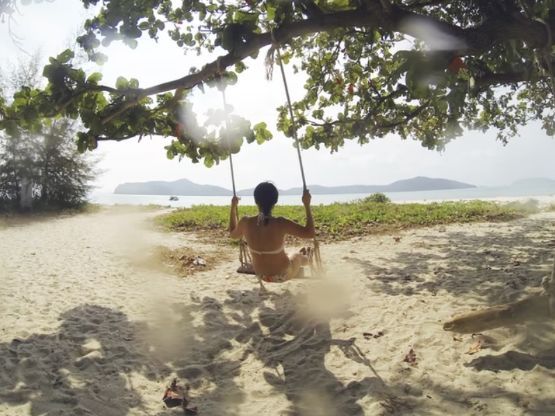 woman on swing on beach