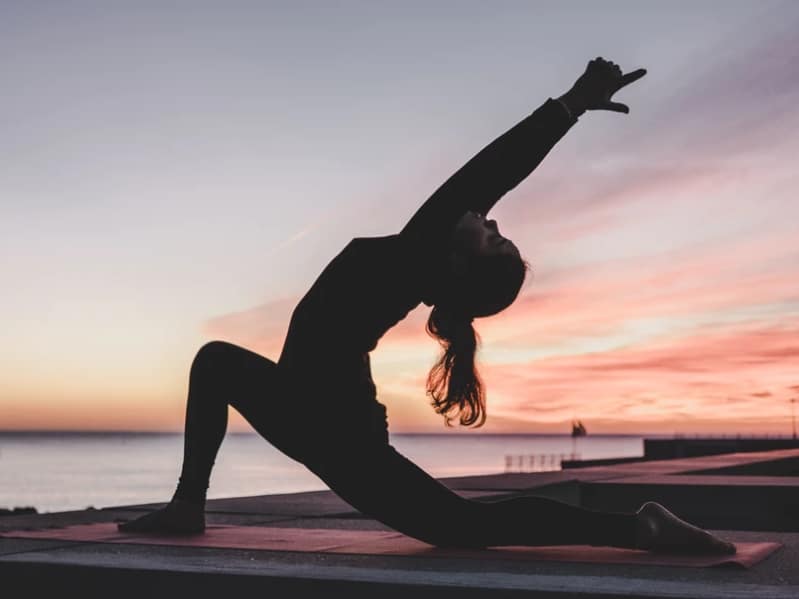 woman practicing yoga outside