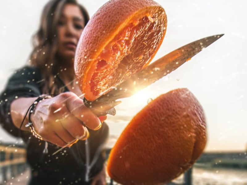 woman slicing orange