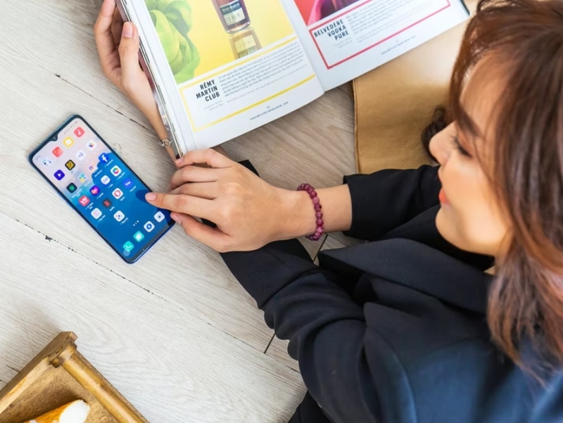 woman smiling at smartphone