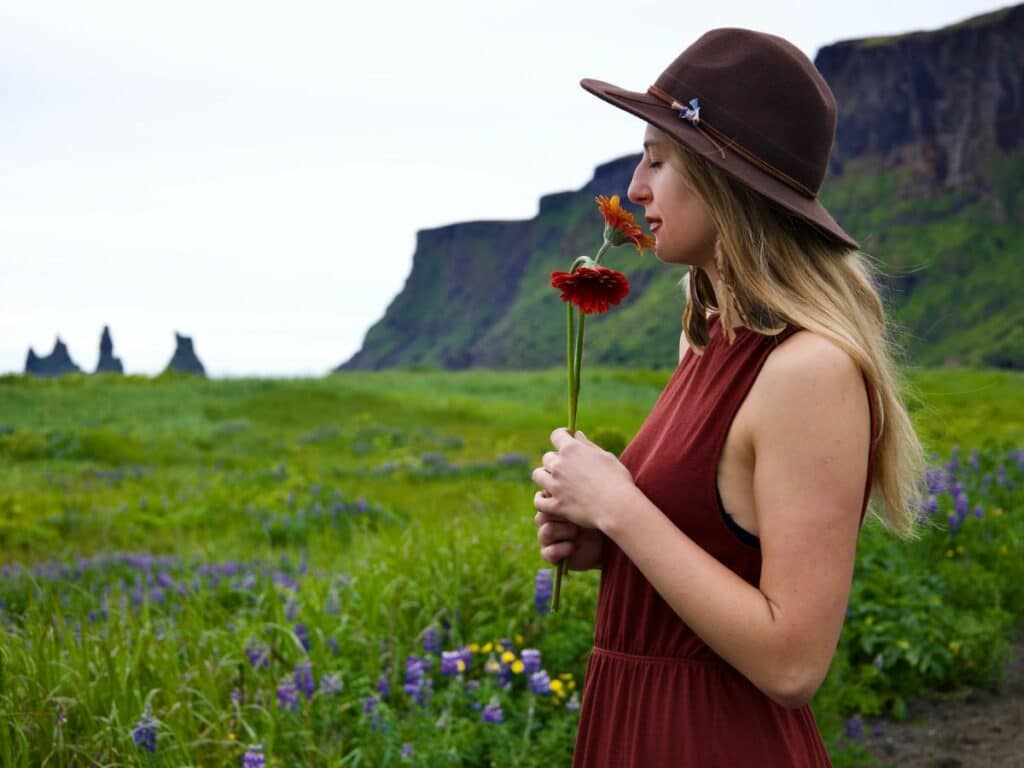 women smelling flowers